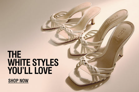 Elegant white strappy heeled sandals arranged on a soft beige background, with bold text reading “The White Styles You’ll Love” and a “Shop Now” call to action.