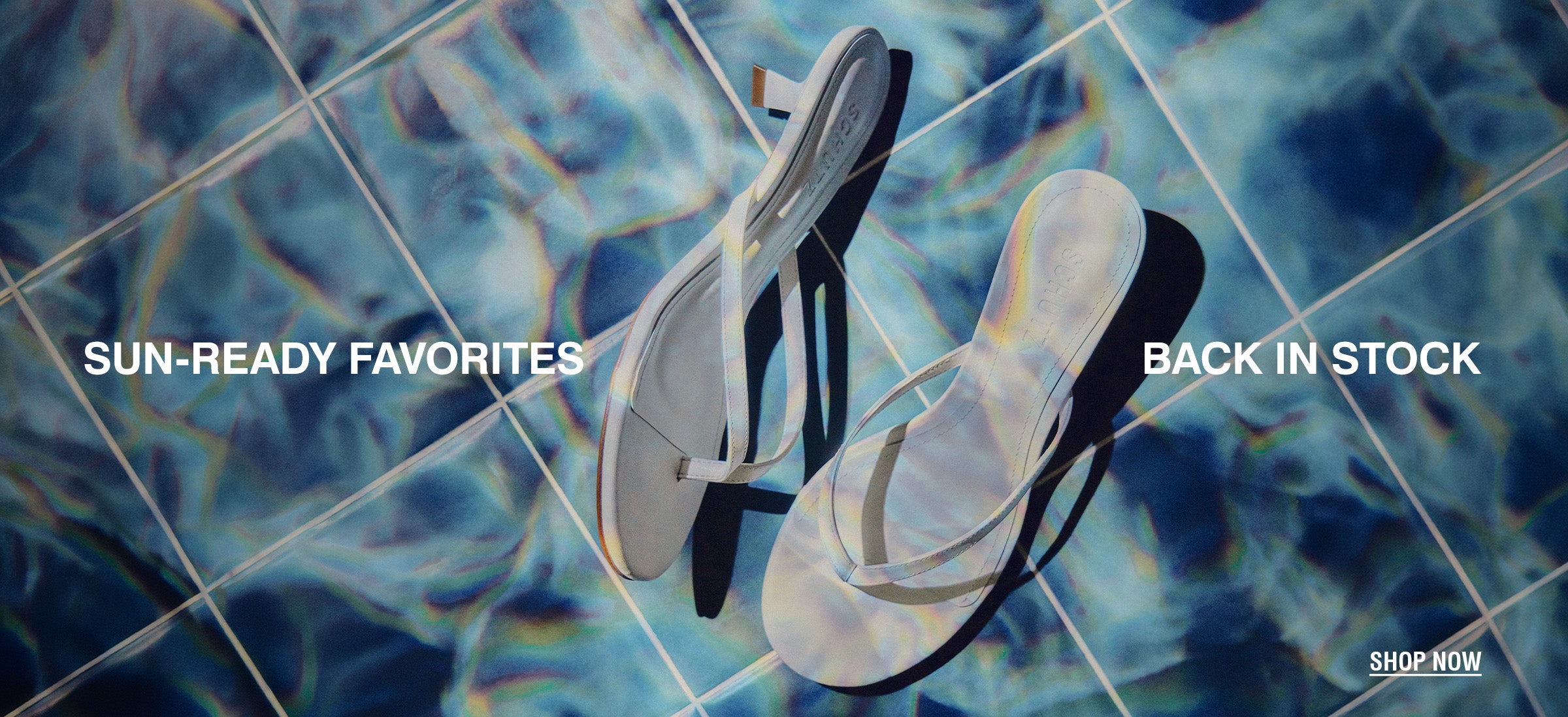 White flip-flops on a sunlit, rippled blue pool surface. Text reads "Summer Favorites Back in Stock." A "Shop Now" button is at the bottom right.