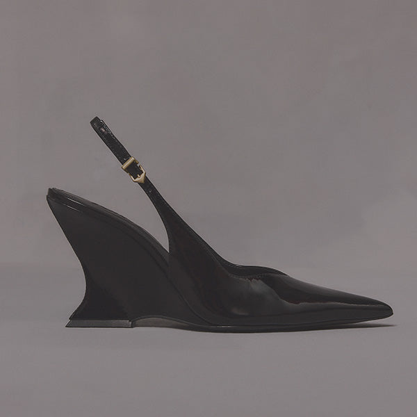 Sleek black high-heeled slingback shoe with a pointed toe and sculpted wedge heel on a gray background; elegant and modern design.