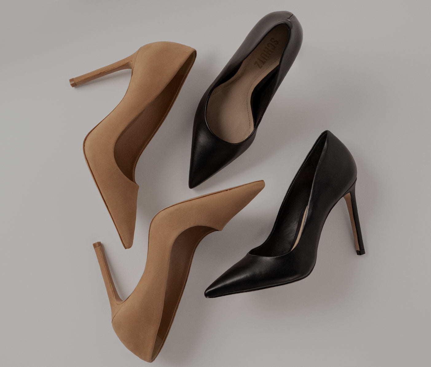 Black and beige pointed-toe leather pumps with stiletto heels.