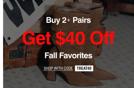 A promotional banner showing a pair of brown pointed-toe heeled boots resting on a vintage brown suitcase against a patterned carpet background. Large red and white text reads 'Buy 2+ Pairs Get $40 Off Fall Favorites SHOP WITH CODE TREAT40'.