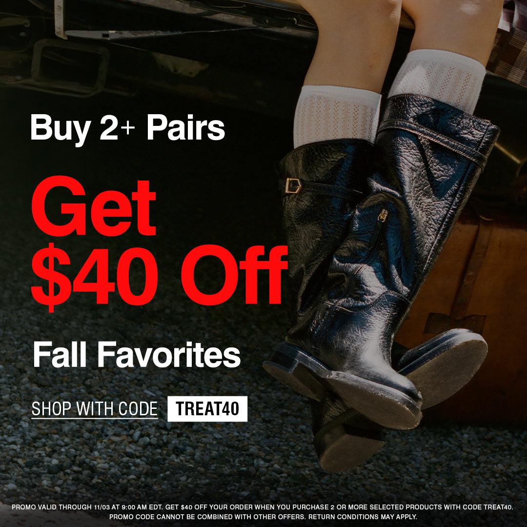 Promotional banner with text reading 'Buy 2+ Pairs Get $40 Off Fall Favorites' and 'SHOP WITH CODE TREAT40' over a dark outdoor scene showing a person's legs wearing shiny black boots next to a brown suitcase.