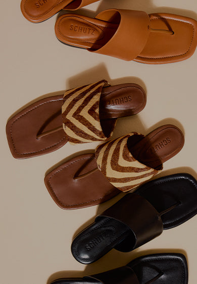 Women’s flat sandals in warm neutral shades, featuring leather finishes and animal print textures, displayed from a top-down perspective.