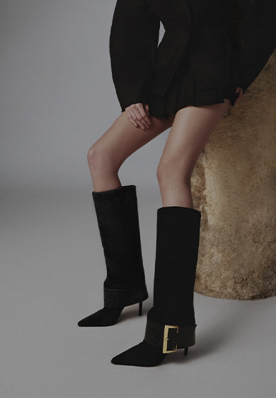Promotional banner showing a model wearing black knee-high heeled boots with a gold buckle detail, styled against a minimalist background, with the text ‘Winter Escapes’ and a subtitle about winter style by Schutz.
