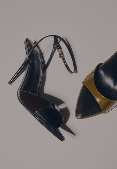 A pair of high-heel sandals in dark and glossy tones placed on a light background, with the text “HIGH HEEL SANDALS” on the left.