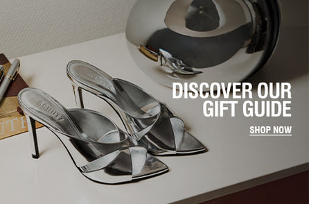 Gold metallic high-heel platform sandal from Schutz, beautifully lit to emphasize its luxurious finish and sculptural silhouette — part of the exclusive Gift Guide collection.