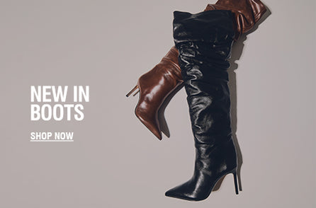 Model wearing black suede slouchy boots from Schutz Boot Shop, styled with a minimal outfit to highlight the sleek pointed-toe design and bold block heel.