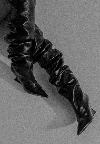 Black slouchy leather knee-high boots with pointed toes, displayed three times in a mirrored layout, with the text “HOLIDAY” at the center.