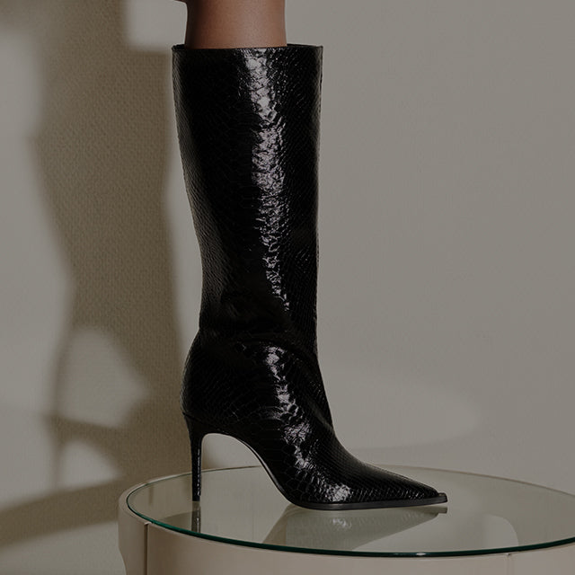 Pair of chic dark gray suede wedge boots, viewed from the side on a bright background, promoting 'STYLES UNDER $300'. Click to explore the collection