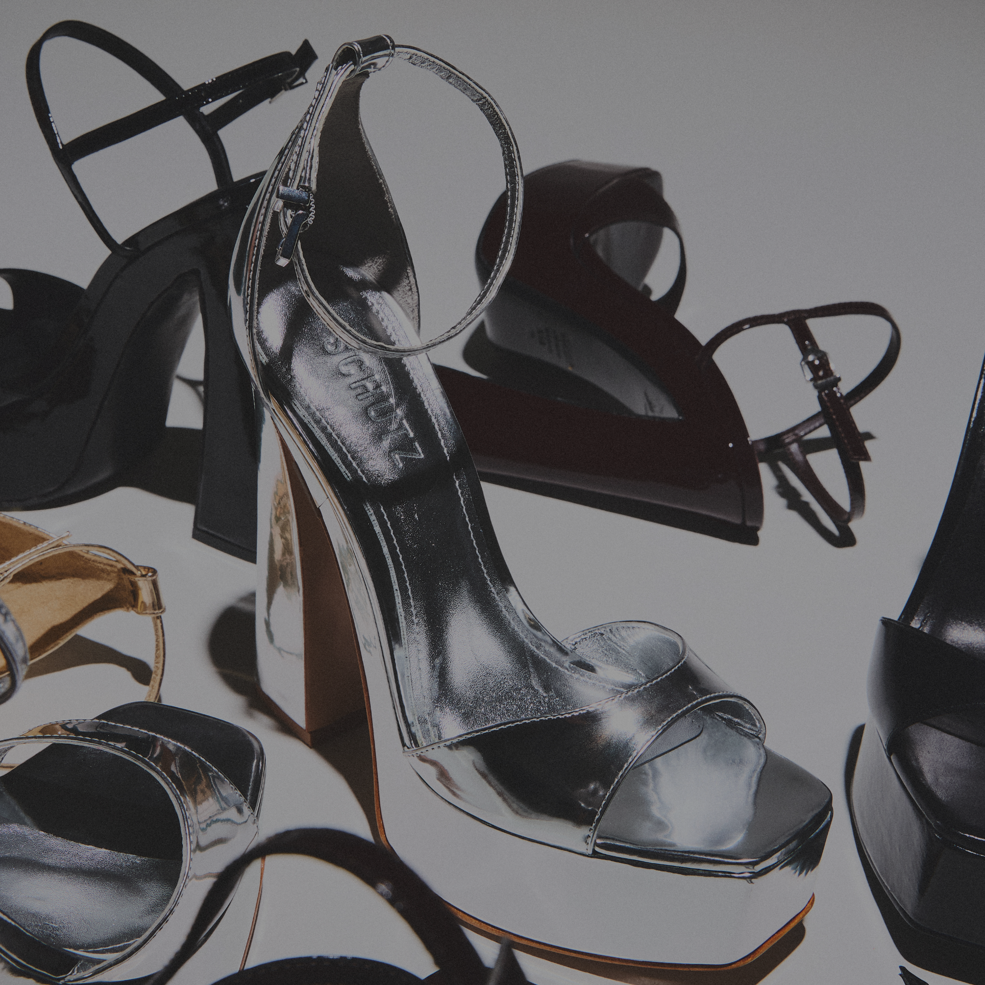 Close-up of brown leather block heel boots on a light stone surface, advertising 'STYLES UNDER $250'. Click to shop now.